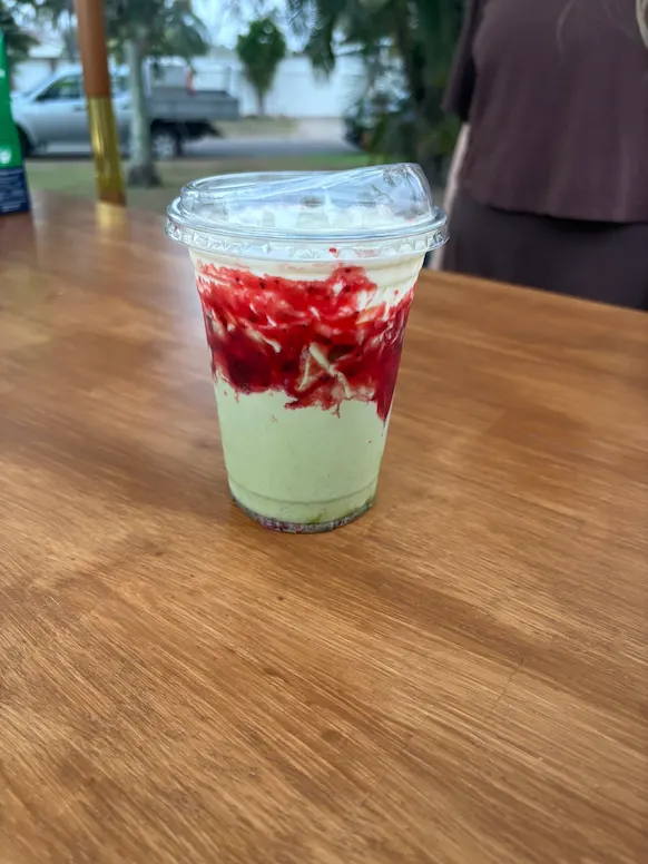 vanila iced matcha with lemon cold foam and strawberry sauce